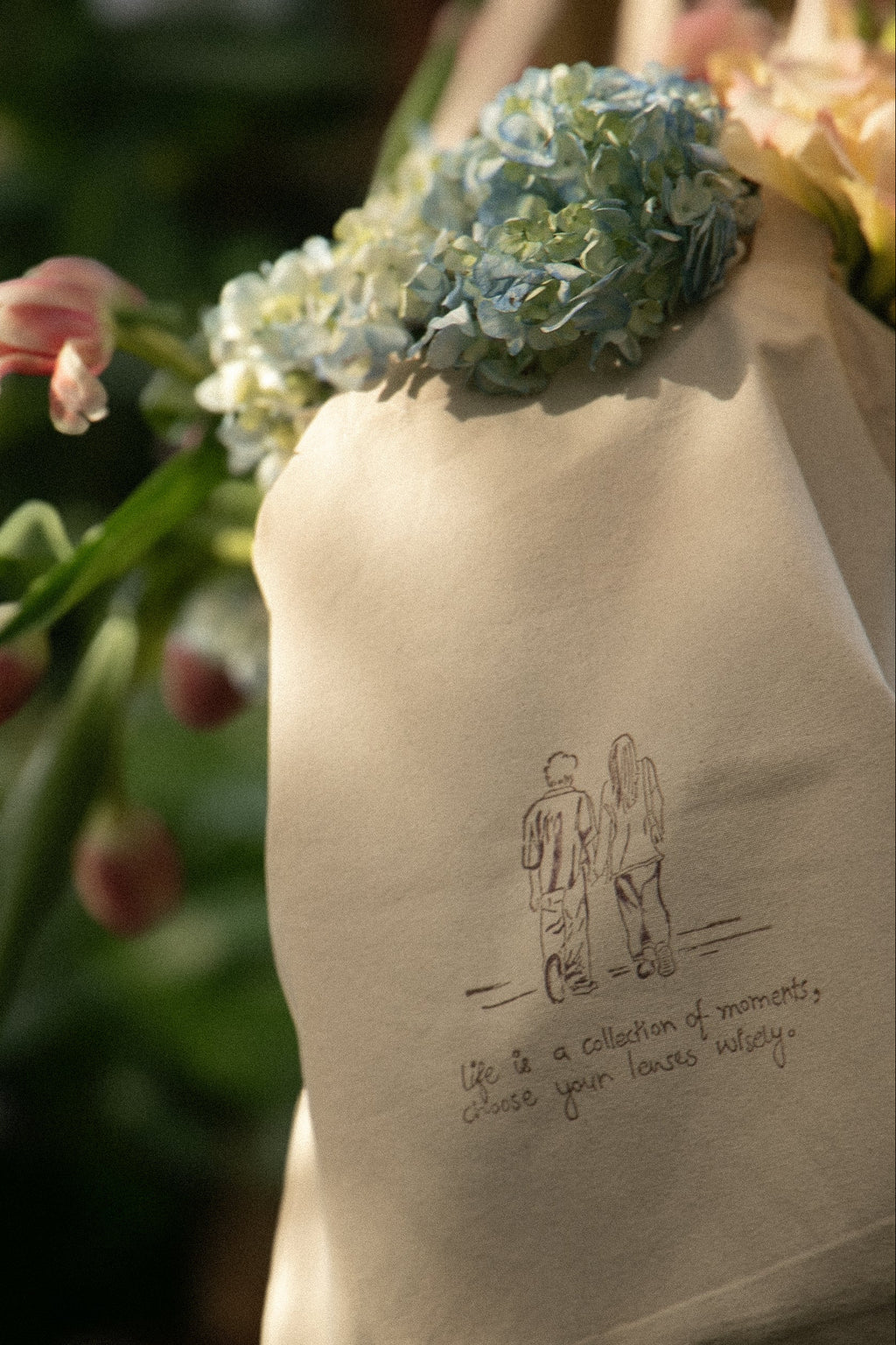 Floral arrangement on a beige fabric with a printed design and text.