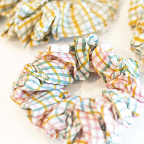 Hand block printed scrunchies in a soft pink with checkered pattern, made from cotton silk fabric.
