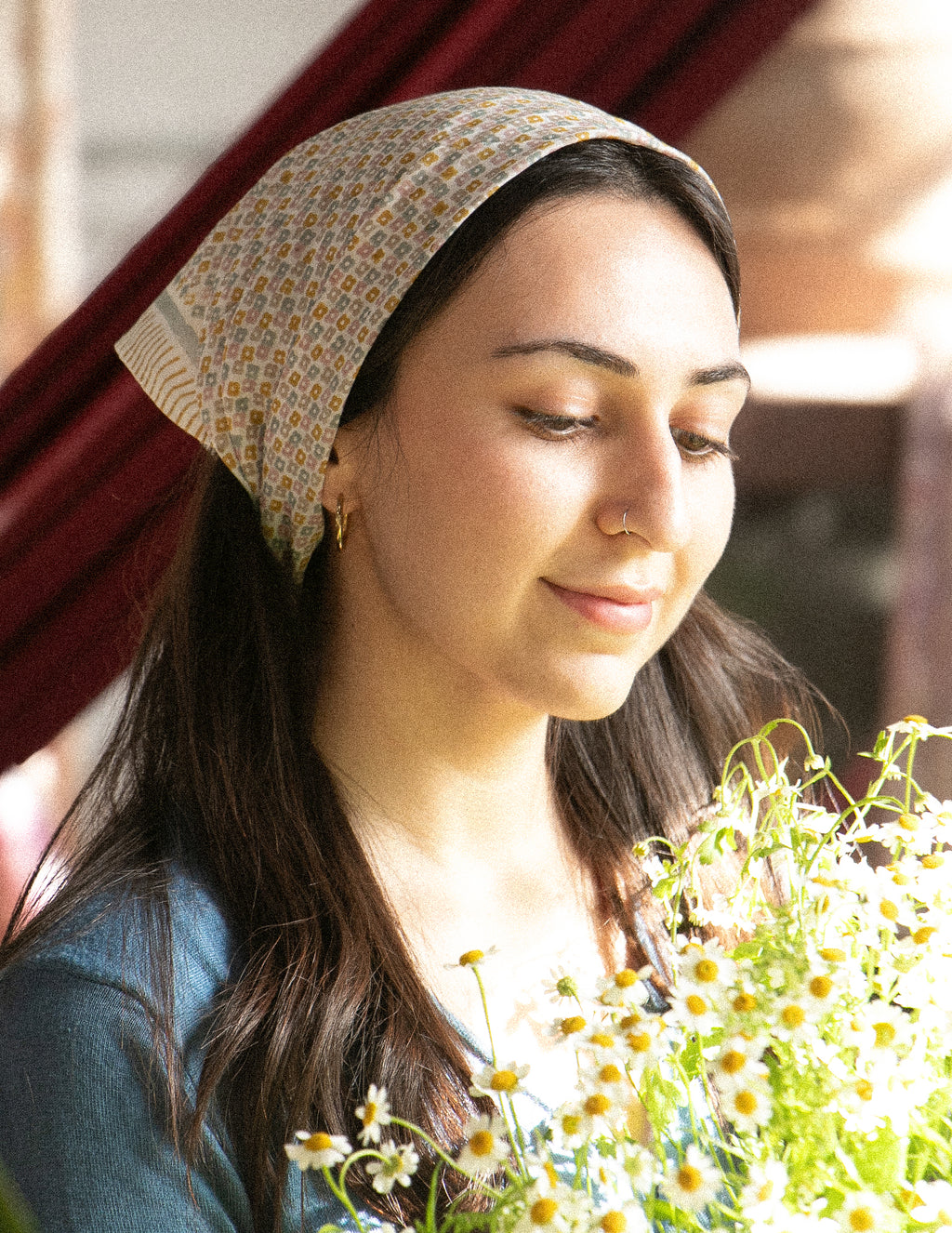 A woman wearing a block printed floral bandana
