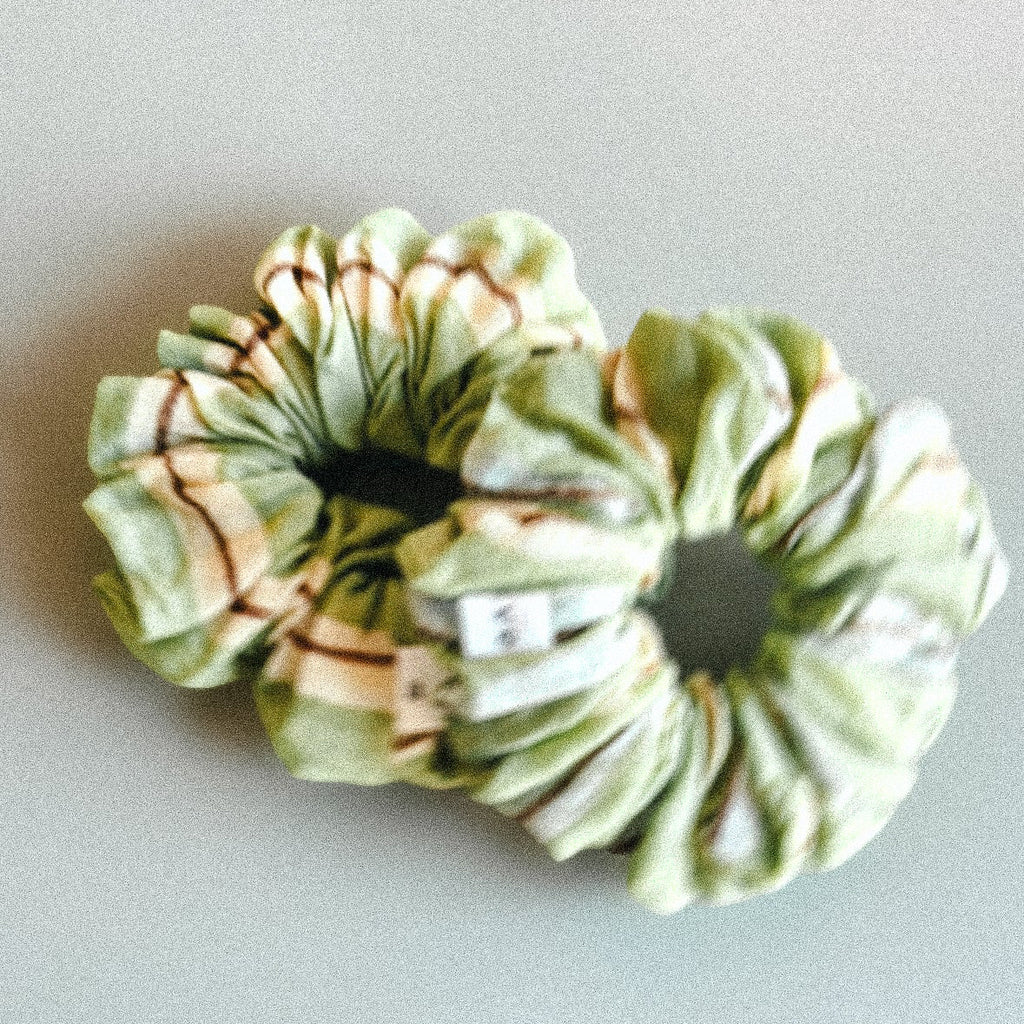 Two green scrunchies made with a block printed technique 