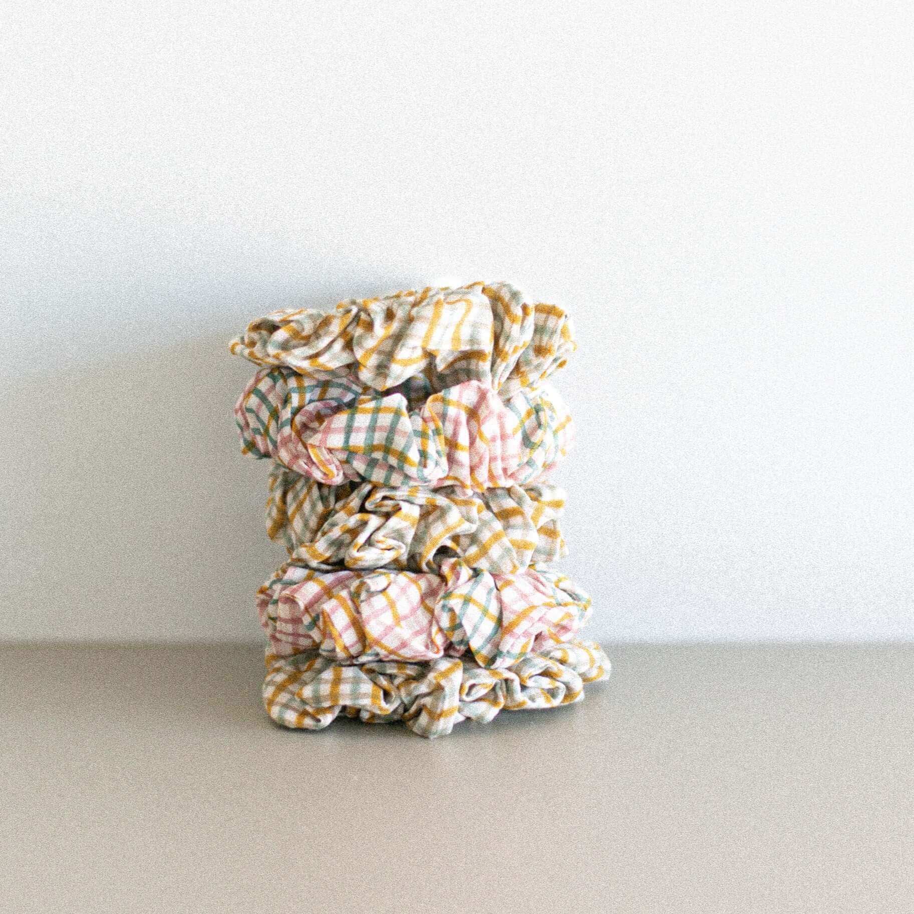 A stack of pink and orange checkered scrunchies - Made in India