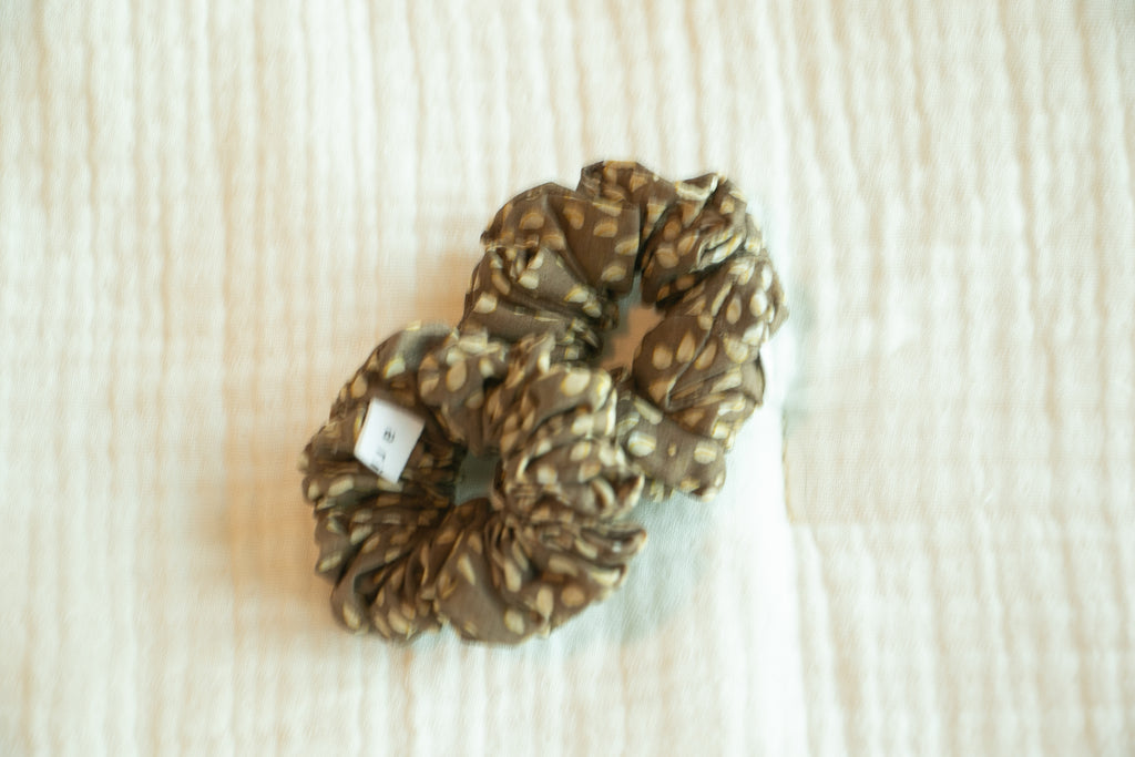 Patterned scrunchie on a textured beige background