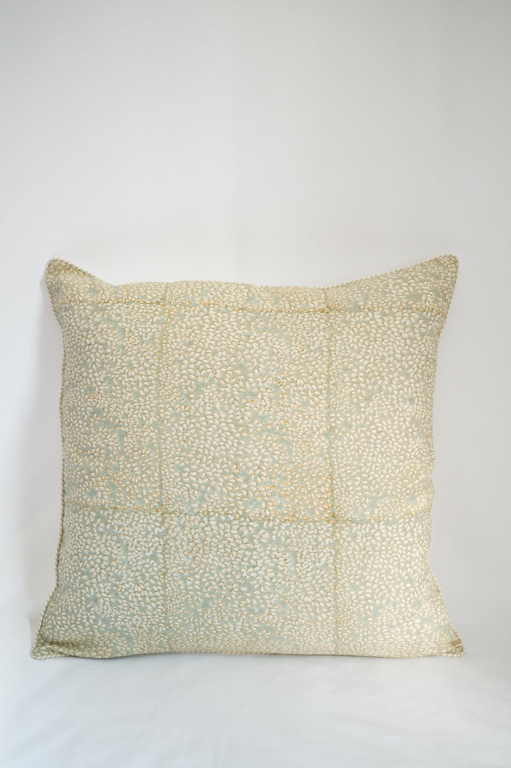 A pair of handcrafted block-printed throw pillows styled on a Linen Fabric for a travel-inspired living room look